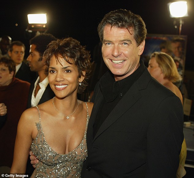 The actress, 58, played Bond Girl Jinx in 2002's Die Another Day opposite Pierce, 71 (pictured at the 2002 premiere)