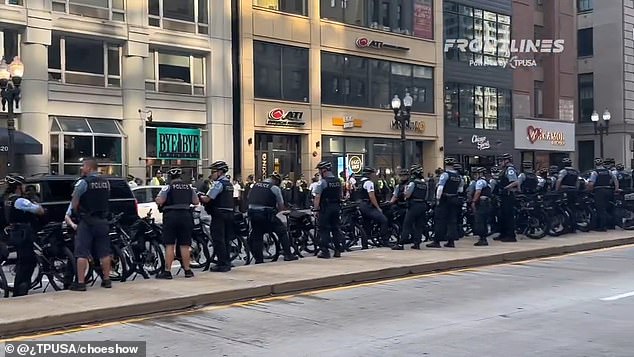 Dozens of police officers can be seen on bicycles gathering to prepare for the influx of protesters