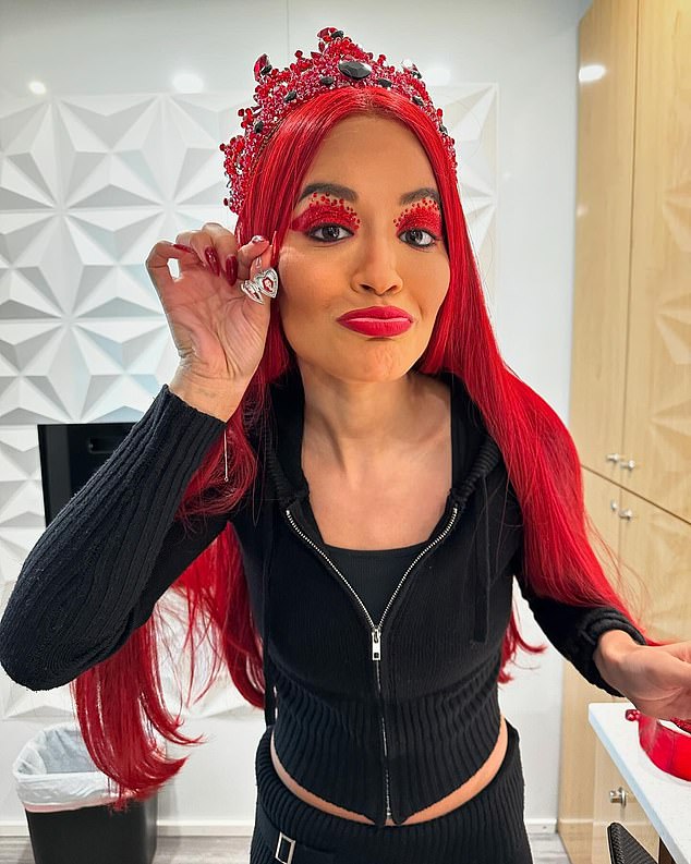 The singer also showed off her flowing wig as she posed with a small locket featuring the photo of her on-screen daughter, YouTuber Kylie Cantrall