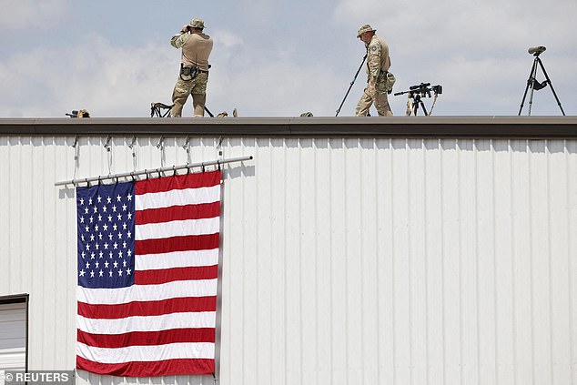 Security forces members stand guard on the day of a campaign rally for former U.S. President Donald Trump at Asheboro Regional Airport in Asheboro, North Carolina, U.S., August 21, 2024