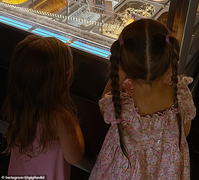 She added a photo of her little one checking out an ice cream parlor with a friend