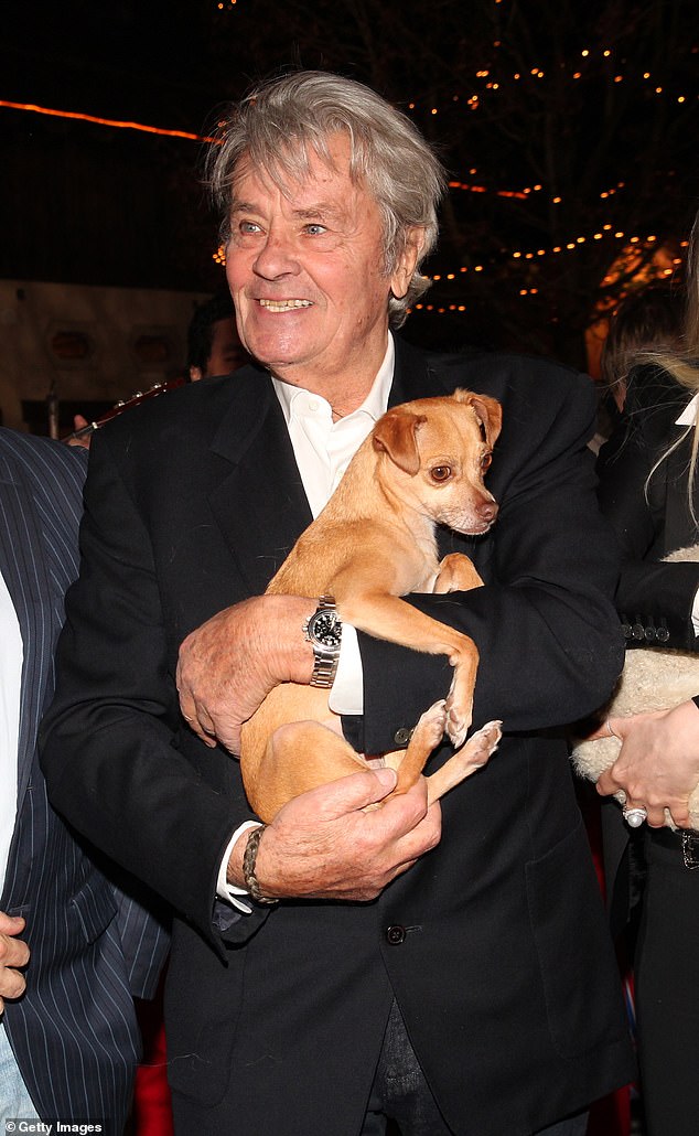 Alain Delon (pictured, with another dog in 2014) said he wanted Loubo, his now 10-year-old Belgian Malinois, to be put down and buried with him