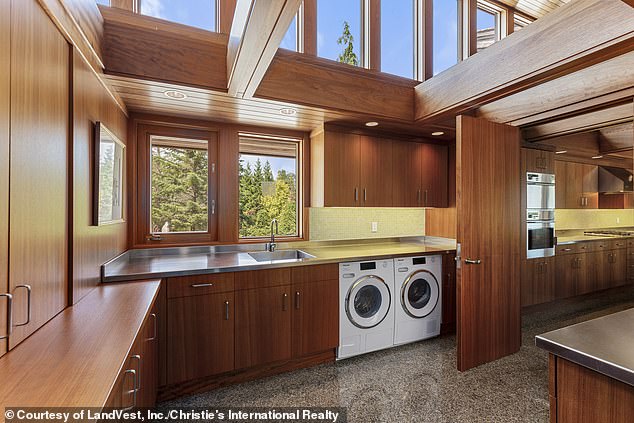 Directly next to the front door is a spacious utility room with washing machine and dryer and plenty of storage space (pictured)