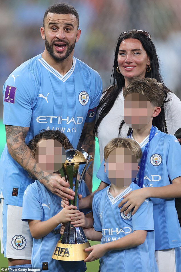 The couple pose with three of their children after the footballer's hometown club, Manchester City, won the FIFA Club World Cup last year