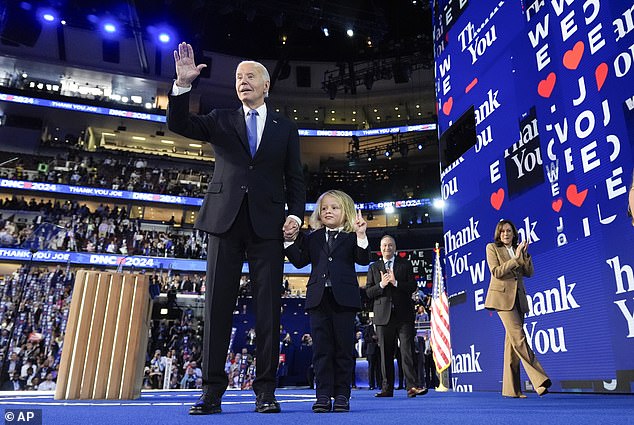 President Joe Biden waves as he stands onstage with his grandson Beau Biden during the Democratic National Convention on Monday, August 19, 2024 in Chicago