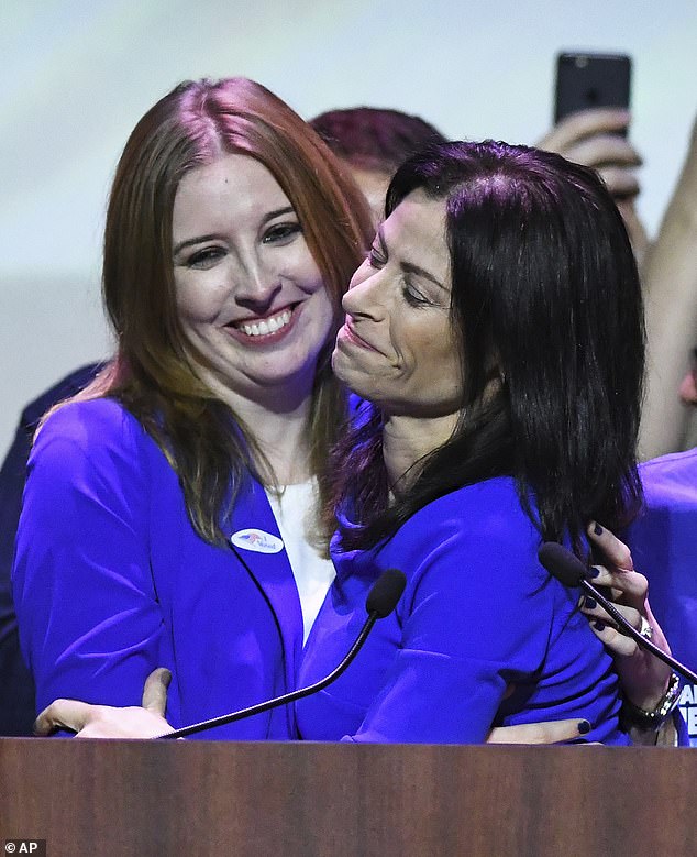 Nessel, right, embraces her wife, Alanna Maguire, at the Michigan Democrats' election night party in Detroit on Tuesday, Nov. 6, 2018.