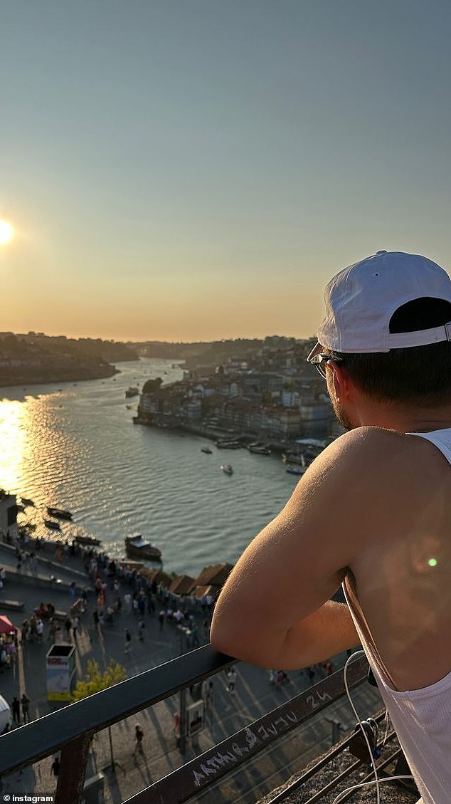 She took a picture of Ray as he looked out at the view from a balcony