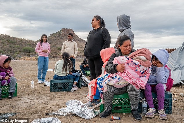 Mexican migrant Veronica Marquez, 36, comforts her son Mariano, 5, as she waits to be apprehended by U.S. Customs and Border Protection officials after crossing the U.S. border on June 25, 2024.