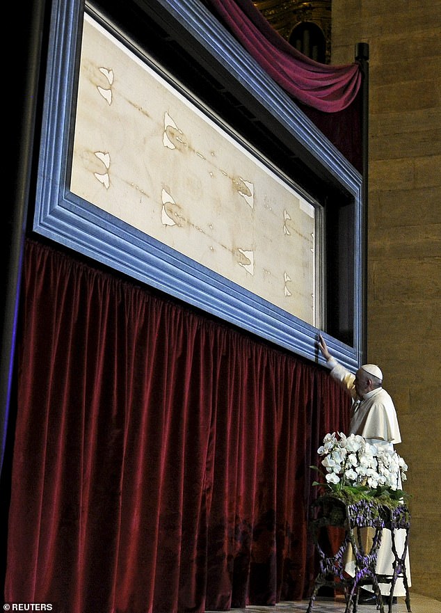 The Shroud first appeared in France in 1354. After initially denouncing it as a fake, the Catholic Church has now embraced it as genuine. In the photo, Pope Francis touches the Shroud of Turin during a visit in 2015