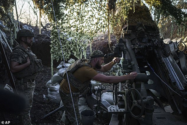 Ukrainian soldier from the 148th Separate Artillery Brigade of the Air Assault Troops prepares his M777 howitzer to fire on Russian positions on the front in the Donetsk region