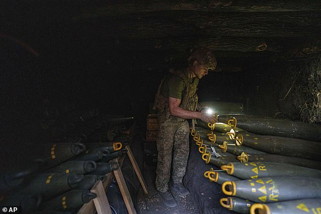 Ukrainian soldier Oleh from the 148th Separate Artillery Brigade of the Air Assault Troops prepares 155mm artillery shells before firing on Russian positions on the front in the Donetsk region