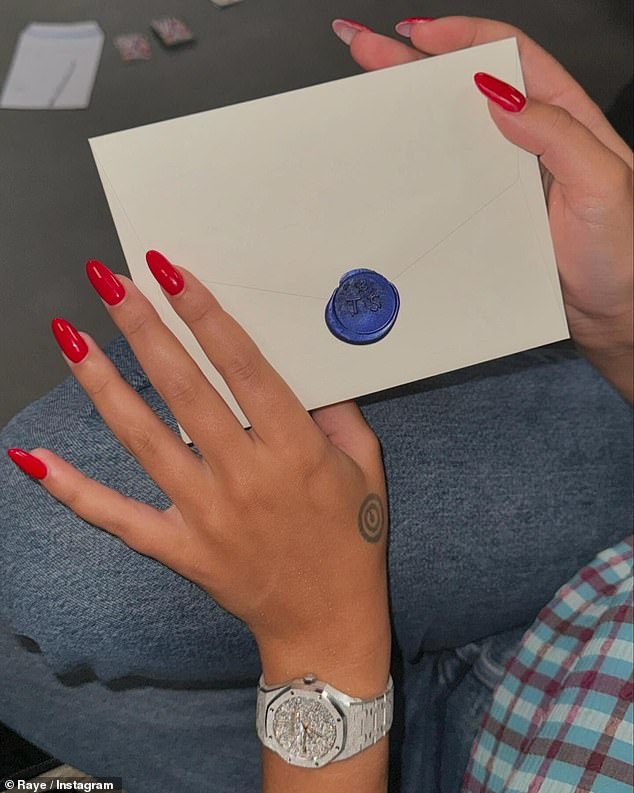 Raye - real name Rachel Agatha Keen - also uploaded an image of the sealed envelope, which showed Taylor's personalized wax seal with her initials 'TS'.