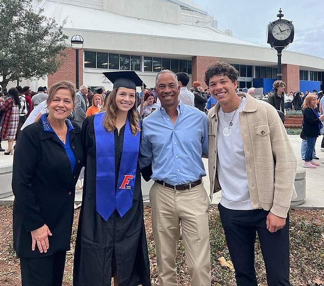 Shelton (right) poses with his family at his sister's graduation ceremony last December