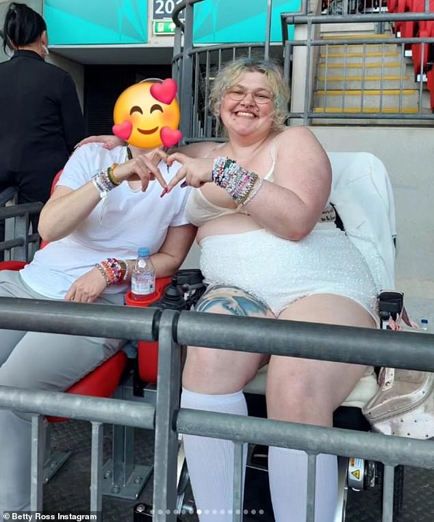 She completed her look with a matching jacket, white knee-high socks and a pair of feather heels as she posed for photos with a friend