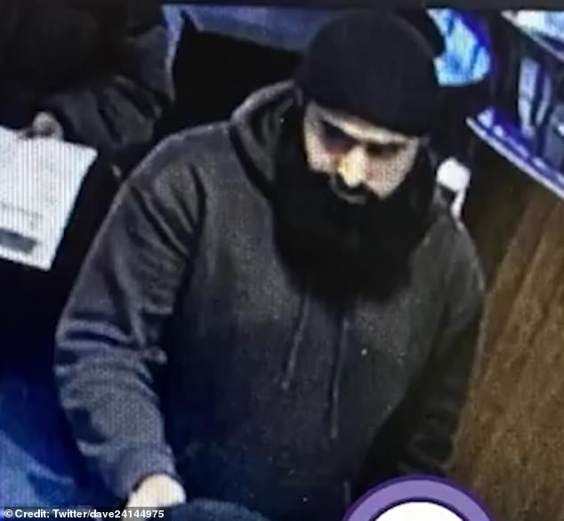 The male suspect, pictured, was filmed punching the woman in the face before leaving the restaurant in Stratford, London. Police are now looking for him