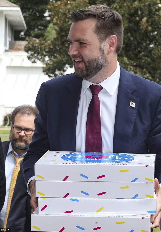 He was seen carrying the boxes of pastries as he left the candy store on his way to a meeting