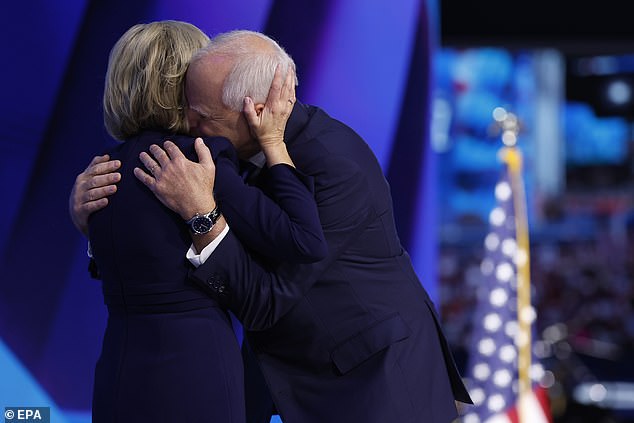 Tim Walz and his wife Gwen embrace on stage during the Democratic National Convention