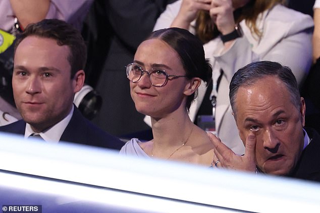 Emhoff wipes away a tear as his wife Kamala Harris begins her speech, while his children and the VP's stepchildren, Cole and Ella Emhoff, look toward the stage