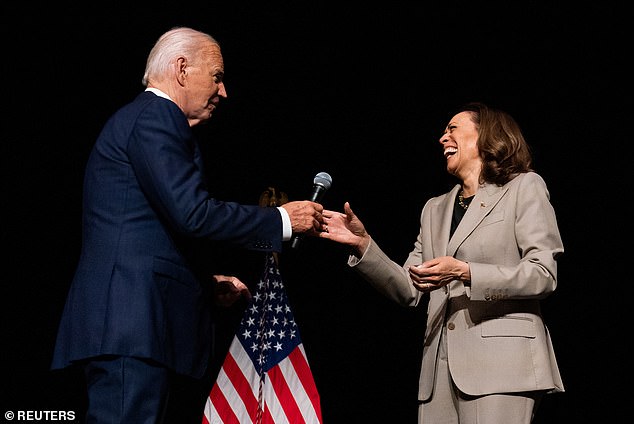 US President Joe Biden hands Vice President and Democratic presidential candidate Kamala Harris the microphone during a rally in Maryland