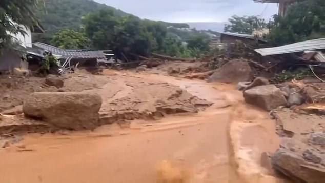 The mud wall crashed into houses, leaving a trail of destruction, photos show