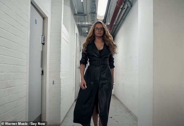 Nadine appears towards the end of the video as she parades down the prison hallway in a black leather jacket and matching lace top