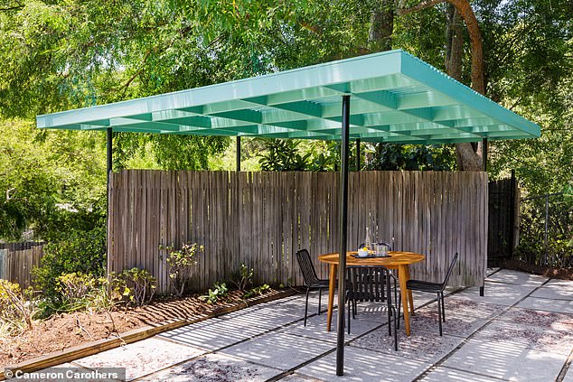 There is a lovely sitting area, covered by a teal awning - perfect for outdoor entertaining