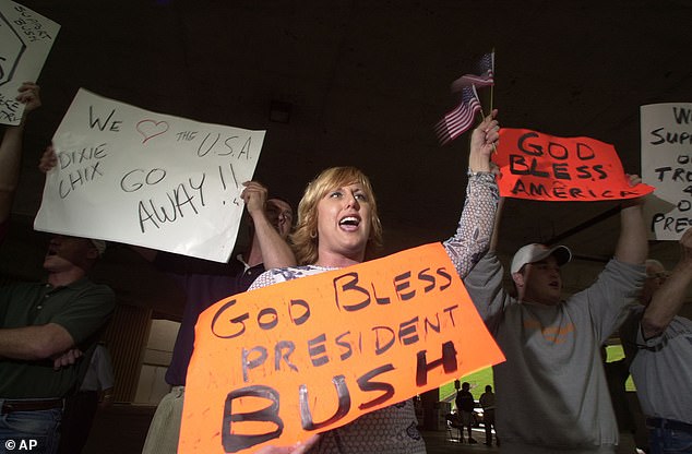 Excited: Her comments enraged their largely conservative fan base, leading to a boycott of their music that devastated album sales and sank their chart position. Pictured above are protesters at a May 2003 concert in Knoxville, Tennessee