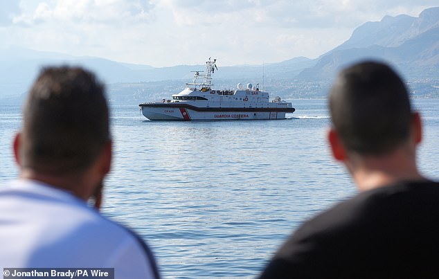 A coast guard boat is on the water this morning near the spot where the ship sank off the coast of Sicily