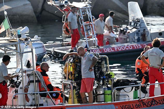 Divers from the Italian fire brigade speak on a rescue boat this morning as they prepare to resume the search for Hannah