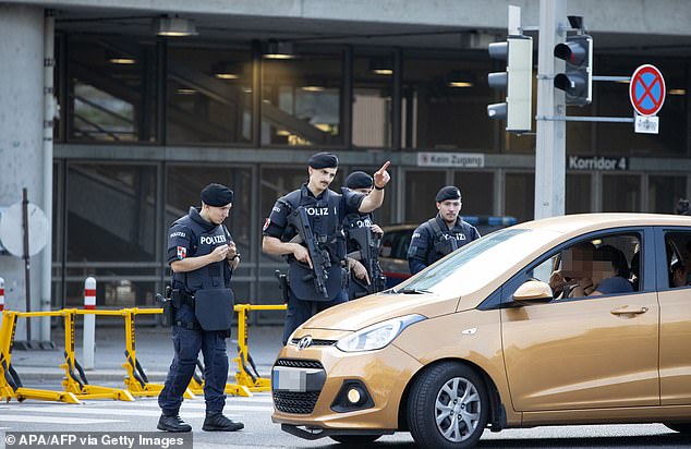 Armed Austrian police officers patrol outside the Ernst Happel Stadium in Vienna, Austria on August 21, 2024