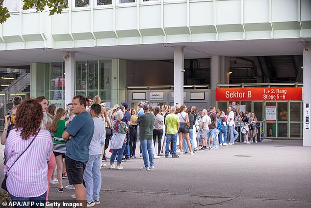 Fans line up outside the Ernst Happel Stadium in Vienna, Austria, on August 21, 2024, ahead of the first concert in a series by British rock band Coldplay