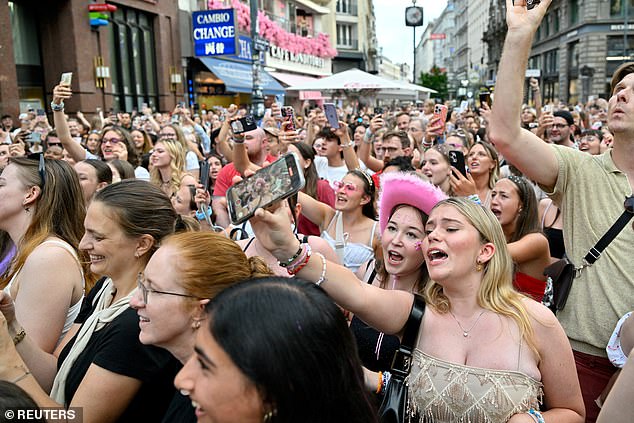 Taylor Swift fans react as they sing together in front of St. Stephen's Cathedral following the cancellation of three Taylor Swift concerts at Ernst Happel Stadium due to a planned attack on the venue, in Vienna, Austria August 9, 2024