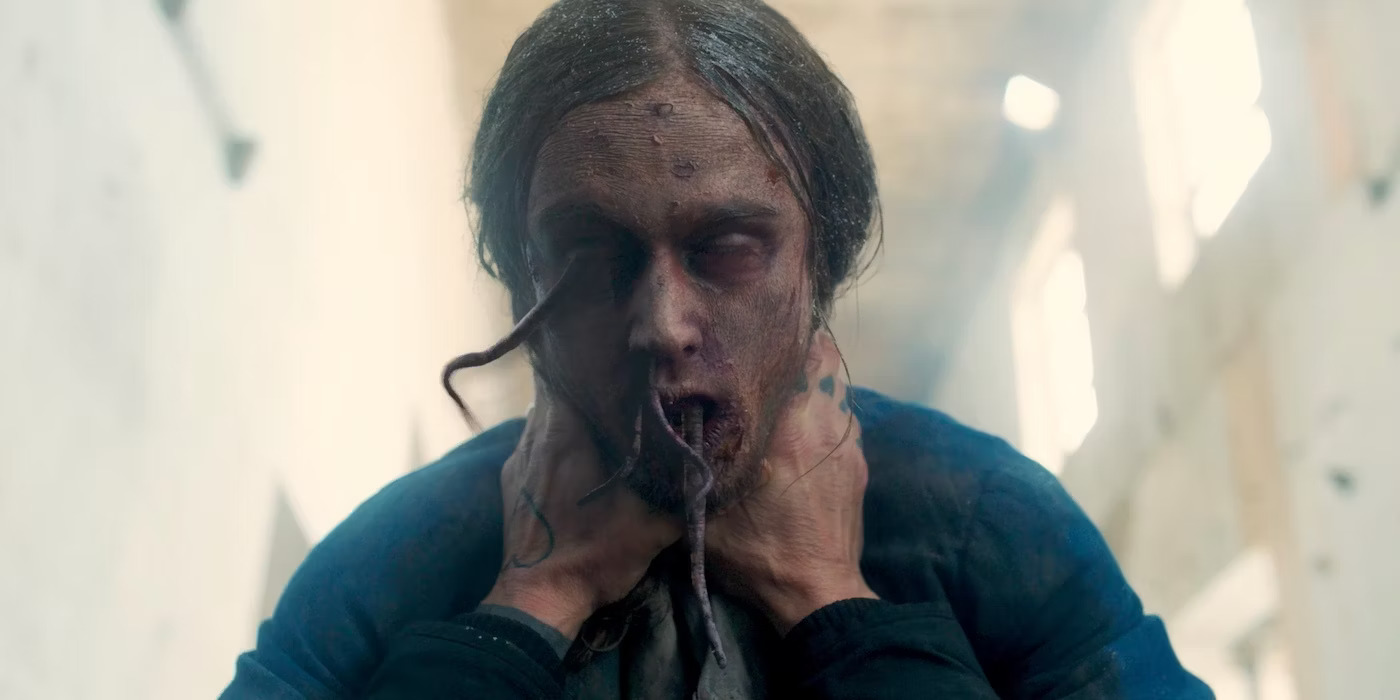 A zombie man with tentacles coming out of his eyes, nose and mouth is being strangled in Hell Hole by someone off-screen.