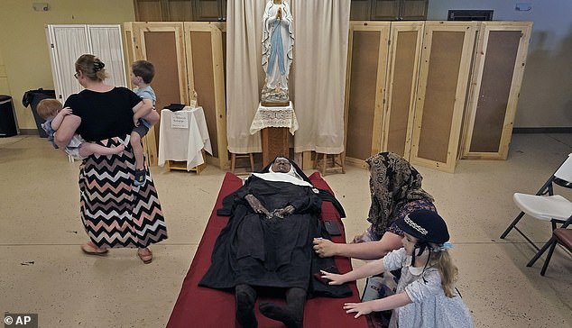 Pictured: People pray before the body of Sister Wilhelmina Lancaster at the Benedictine Abbey of Mary, Queen of the Apostles on Sunday, May 28, 2023