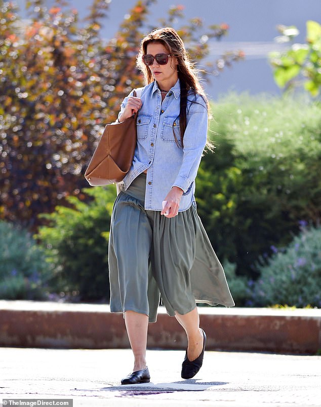 Black ballet flats looked comfortable as she carried a tan leather Khaite bag on her shoulder, as well as a satchel. With minimal makeup and large sunglasses covering her face, the star seemed to be flying under the radar