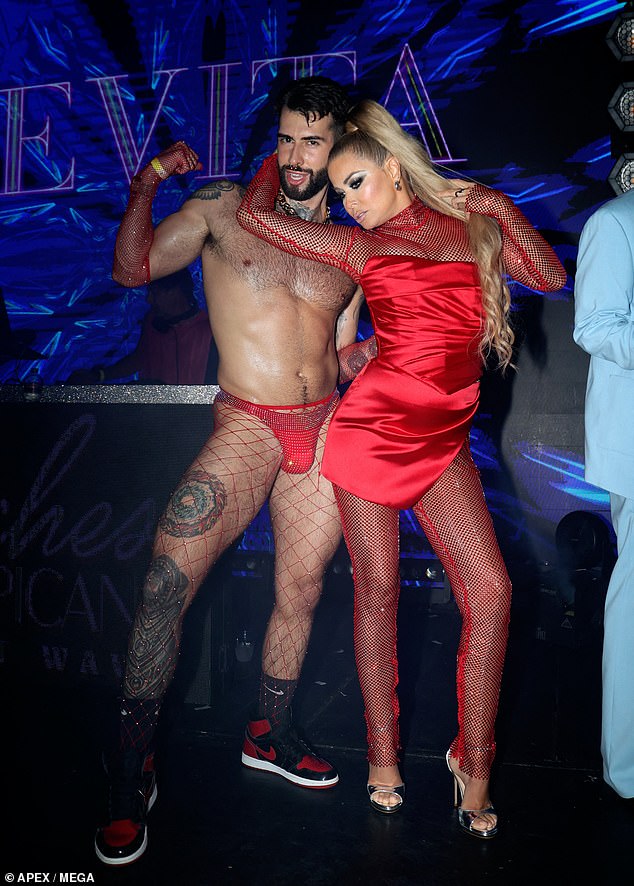 Carmen was seen dancing with a scantily clad dancer in a red thong and fishnet tights