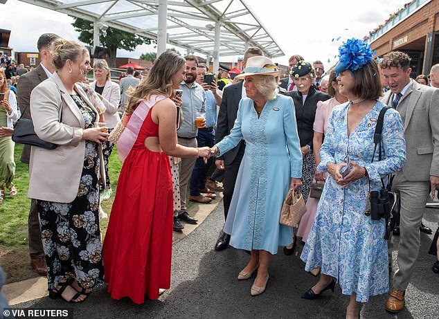 Queen Camilla, as patron of York Racecourse, meets racegoers at the Ebor Festival in York this afternoon