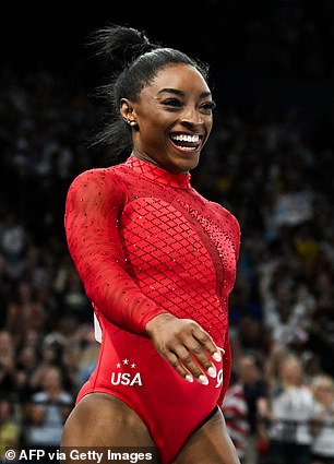 Simone Biles is seen in a red leotard at the Paris Olympics