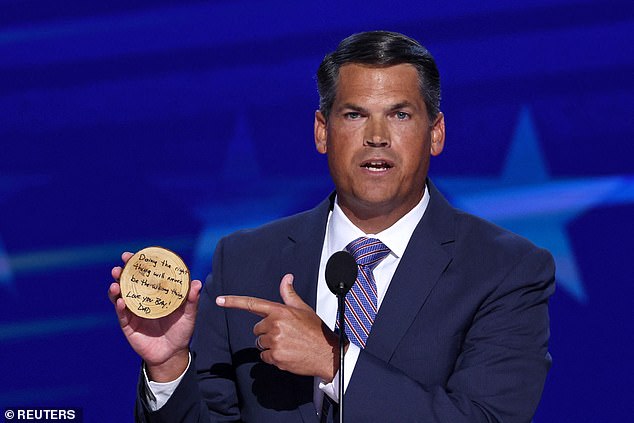 Former Republican Georgia Lt. Gov. Geoff Duncan holds up a note from his son at the DNC that reads 'doing the right thing is never doing the wrong thing'