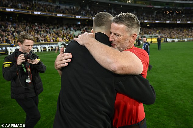 Gold Coast coach Damien Hardwick embraces Martin after his Suns spoiled the farewell party with a win that took them to their best record in an AFL season