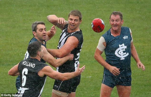 David's other AFL star son, Cameron (pictured centre during a match in 2014), was levelled by an off-the-ball hit in Melbourne in 2023