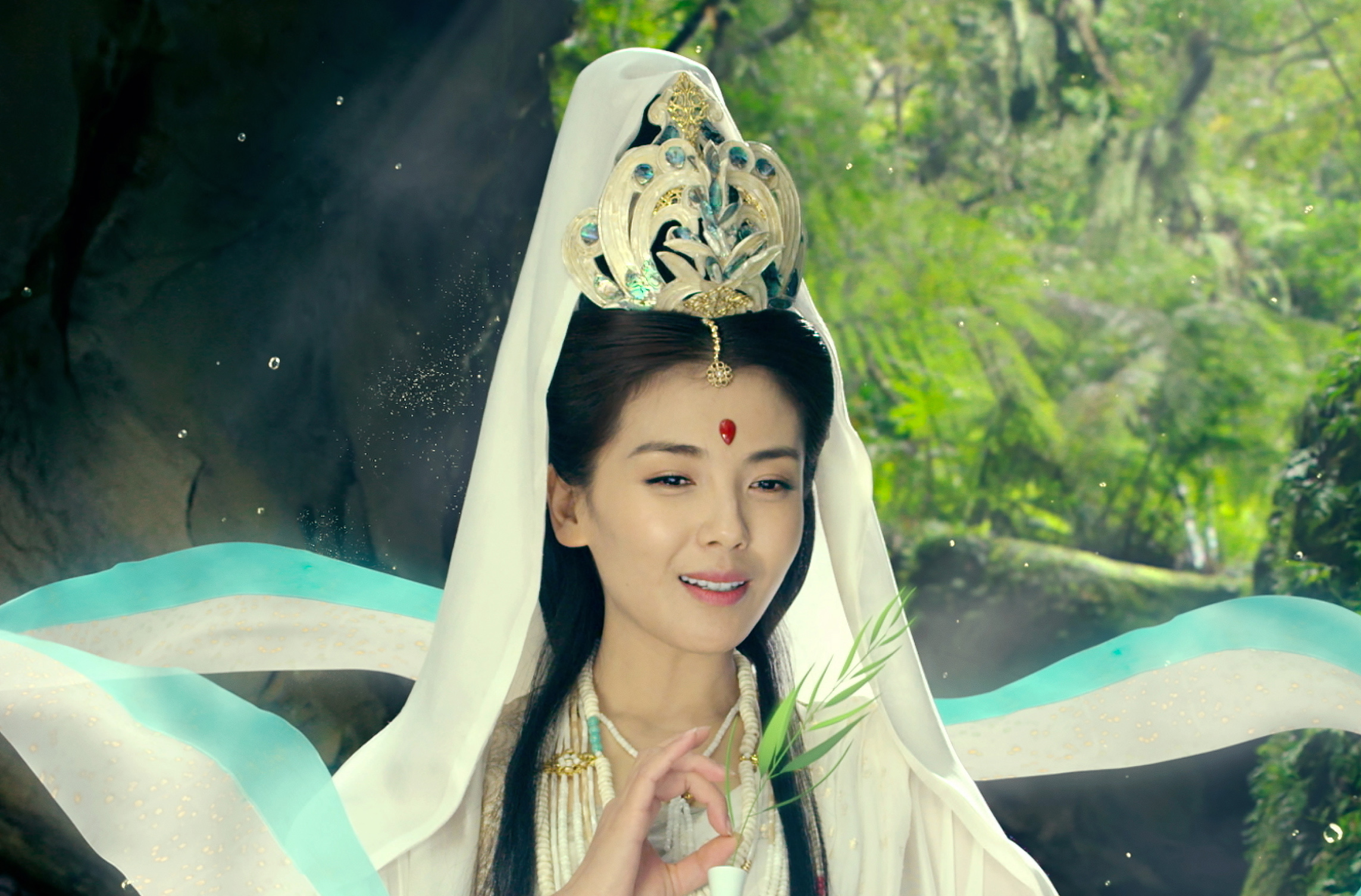 A woman wearing a headdress sits in the forest in The Monkey King 3 