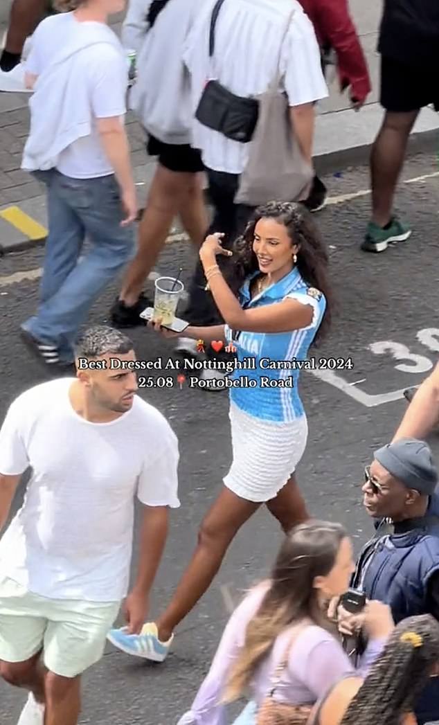 The 30-year-old Love Island host was spotted walking past her fellow festival-goers, while carrying a drink and enjoying the party on Portobello Road