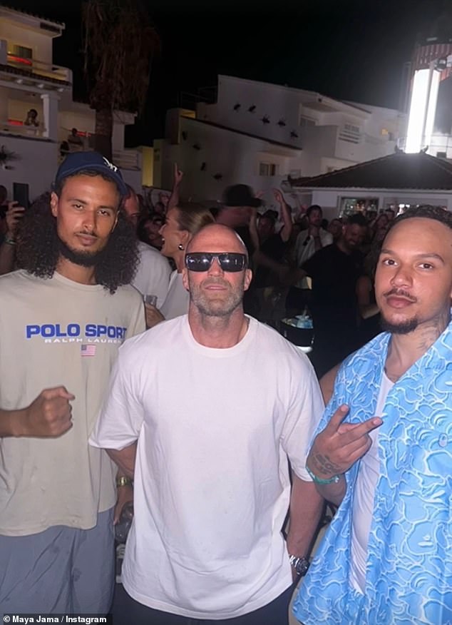 She was spotted being serenaded by dancers at the famous O Beach club and partying with actors including Jason Statham (pictured)