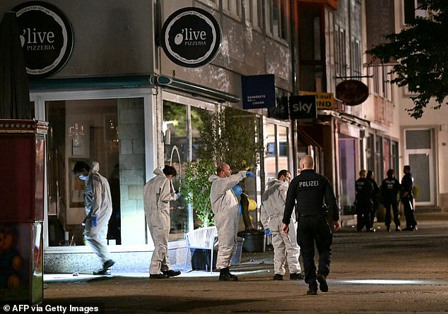 Forensic police inspect the area where at least three people were killed and several injured when a man attacked them with a knife in Solingen in late August 2024, early on August 24, 2024