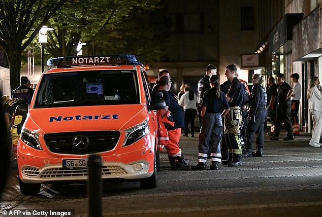 An ambulance and police stand at the scene where at least three people were killed and several injured on August 24, 2024