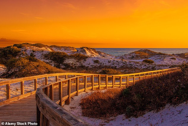 Sunset on a boardwalk leading to Rosemary Beach