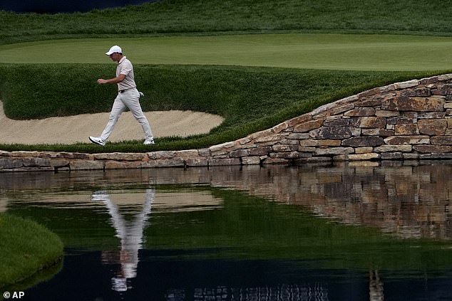 The four-time major champion angrily picked his club out of the water before storming off