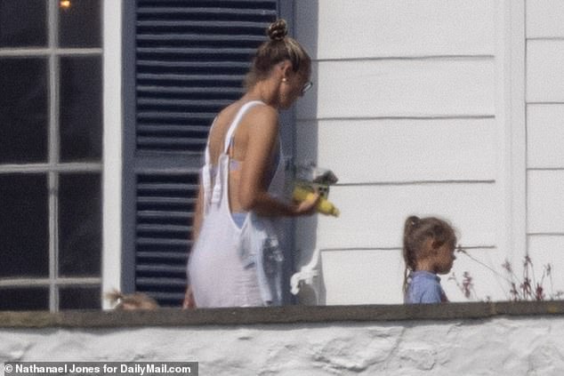 Kylie Kelce was also in attendance at the birthday party, wearing a baby blue bikini with white dungarees as she accompanied her daughter to the pool