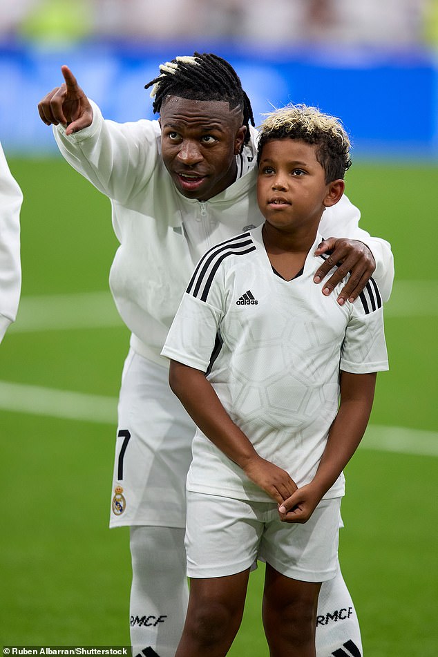 Kim watched from the stands as Saint looked delighted as he walked onto the pitch with the players for their 3-1 win over Valladolid; pictured with Vinicius Jr.